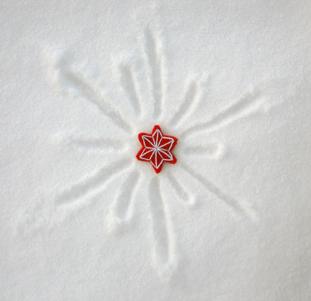 photo of two tone star decoration in the snow