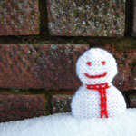 photo of snowman decoration in snow