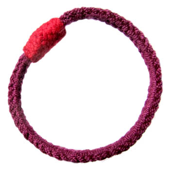 simple cord bracelet with a knitted bead join